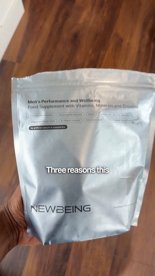 Still from a NewBeing reel: a hand holding a NEWBEING performance supplement pouch